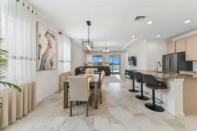 a large kitchen with a table and chairs