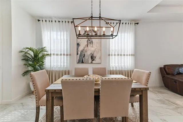a dining room with furniture and window