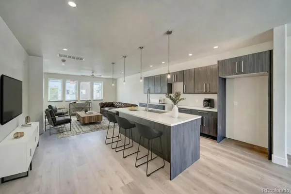 a kitchen with counter top space a sink appliances and cabinets