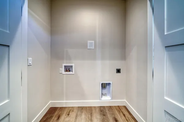 a bathroom with a toilet a sink a mirror a bathtub and vanity