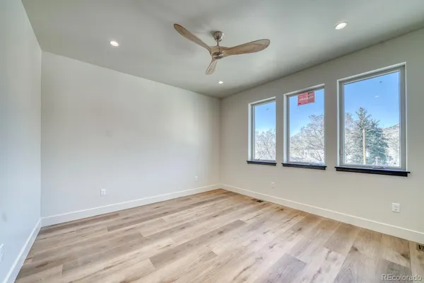 a large bedroom with a bed and a couch