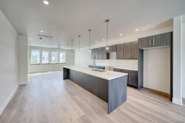 a large kitchen with stainless steel appliances kitchen island wooden cabinets and granite counter tops