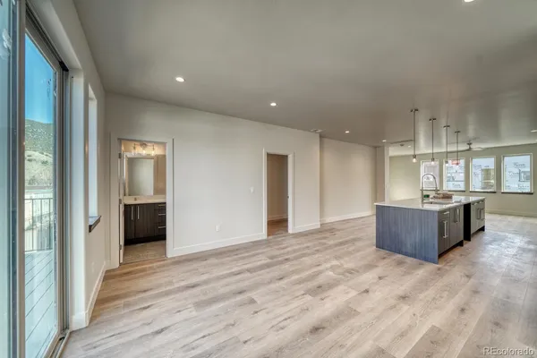 a kitchen with kitchen island a sink stove and wooden floor