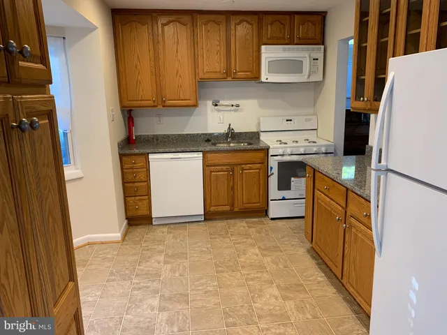 a kitchen with a refrigerator sink and stove