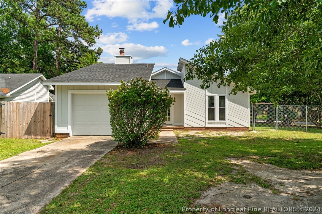 a front view of a house with a garden and yard