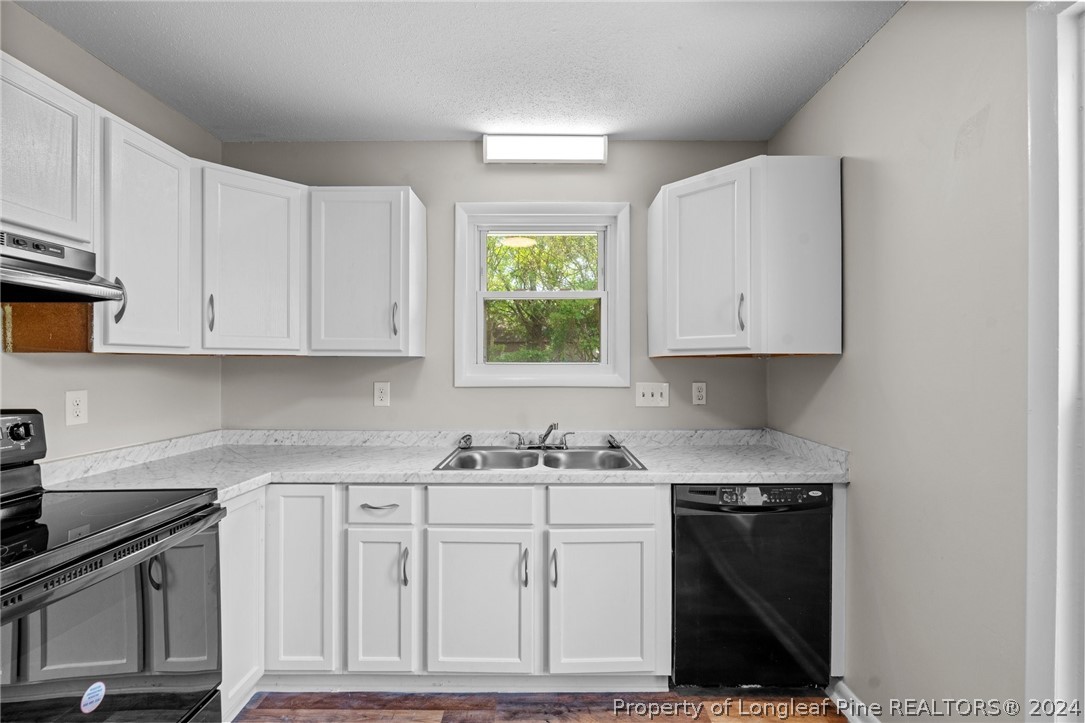 112 Maranatha Circle Spring Lake, NC 28390 - Photo 19 of 33 a kitchen with white cabinets and sink
