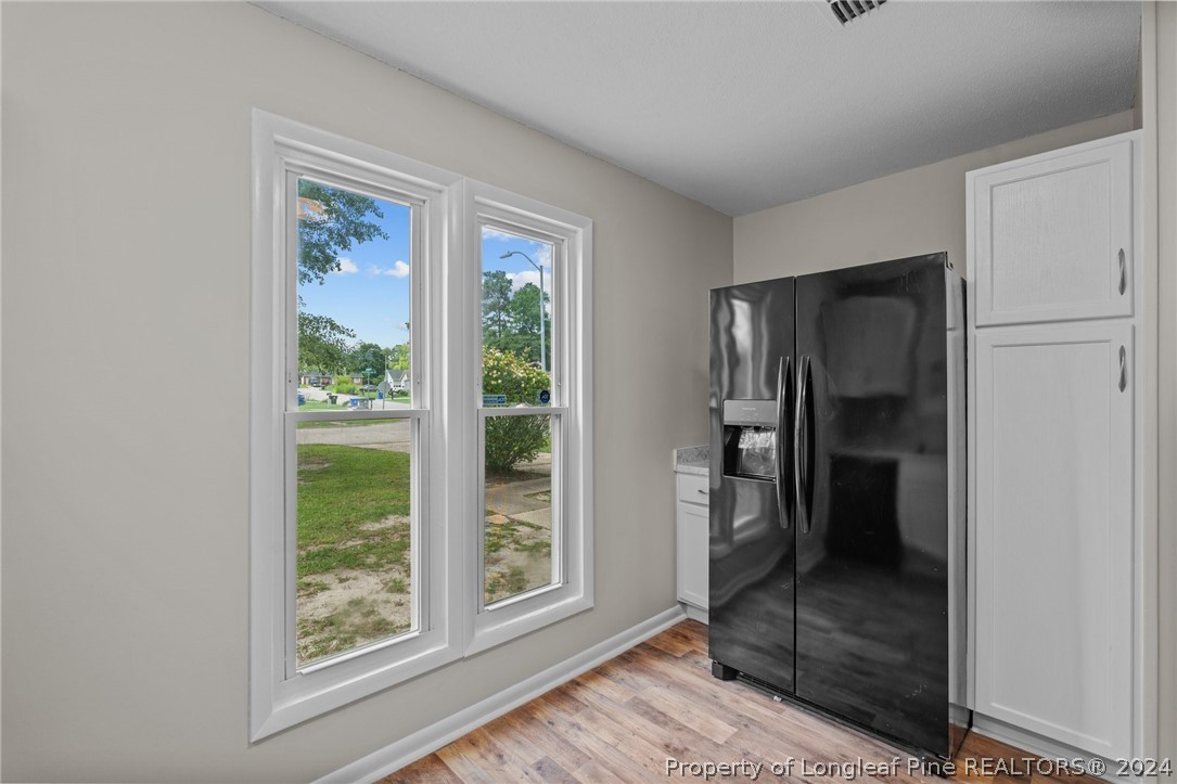 112 Maranatha Circle Spring Lake, NC 28390 - Photo 21 of 33 a view of an empty room with a window and wooden floor