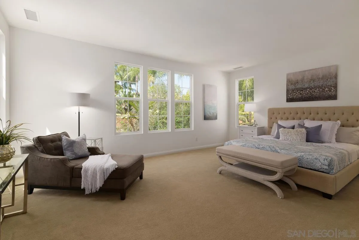 7542 Circulo Sequoia Carlsbad, CA 92009 - Photo 13 of 24 a spacious bedroom with a bed and a couch