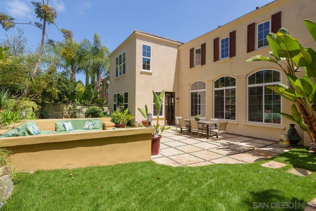 7542 Circulo Sequoia Carlsbad, CA 92009 - Photo 20 of 24 a view of a house with patio and a yard