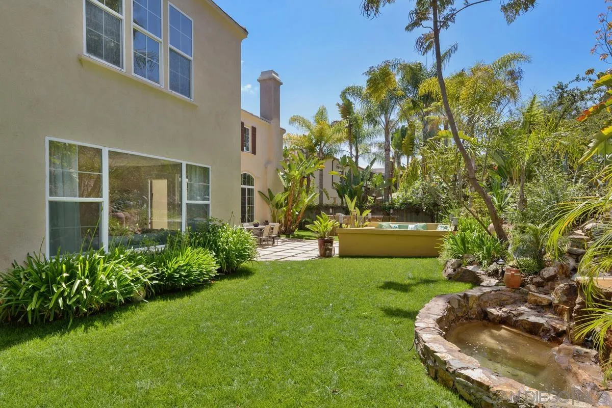 7542 Circulo Sequoia Carlsbad, CA 92009 - Photo 22 of 24 a front view of a house with a yard