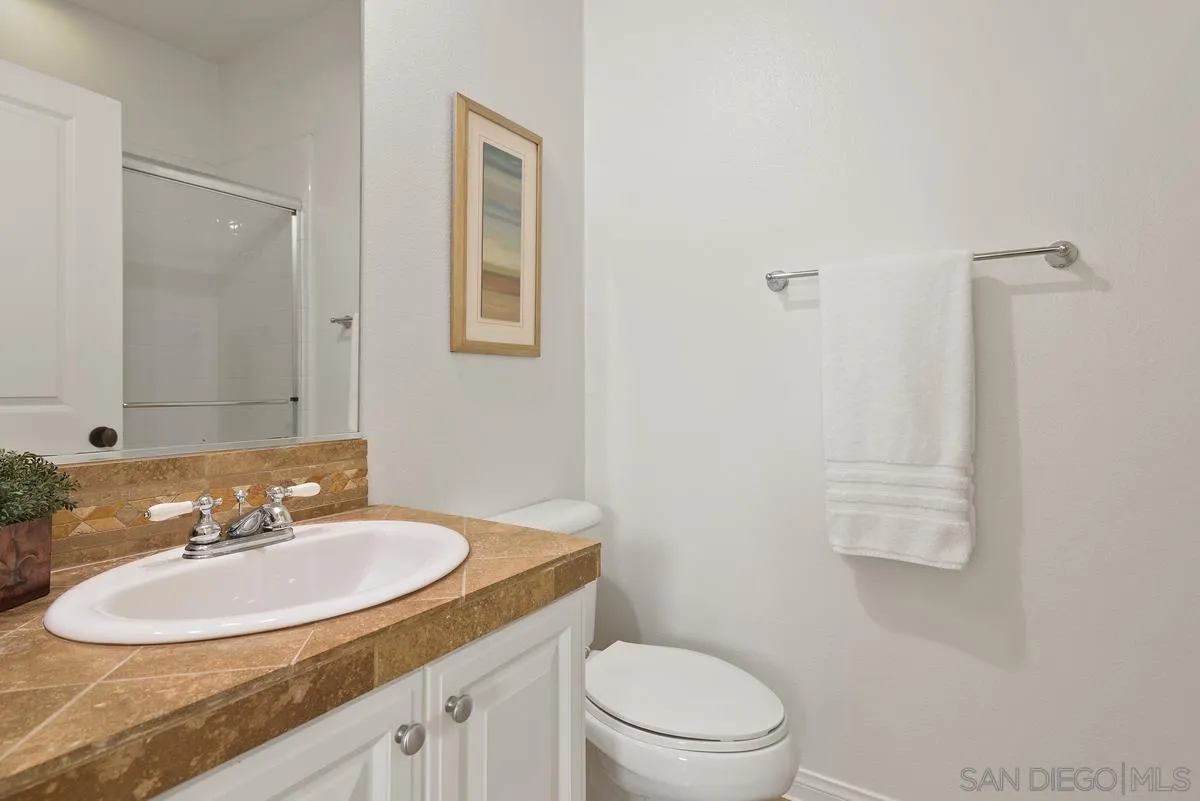 7542 Circulo Sequoia Carlsbad, CA 92009 - Photo 10 of 24 a bathroom with a sink and a mirror
