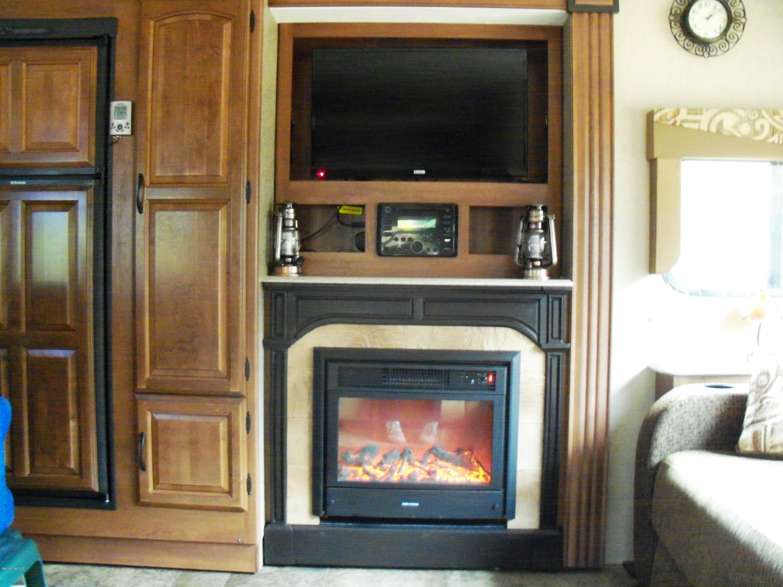 20 S Road Peru, MA 01235 - Photo 14 of 24 a living room with a fireplace and a flat screen tv