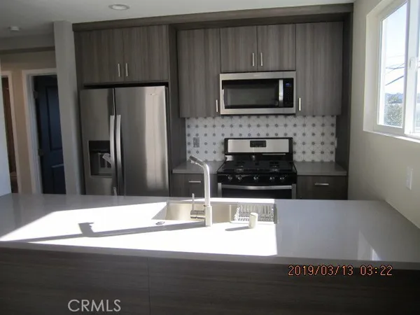 a kitchen with a refrigerator and a microwave