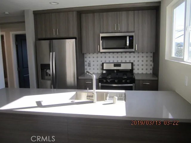 a kitchen with a refrigerator and a microwave