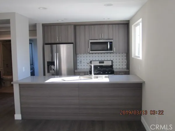 a kitchen with stainless steel appliances a refrigerator and a stove
