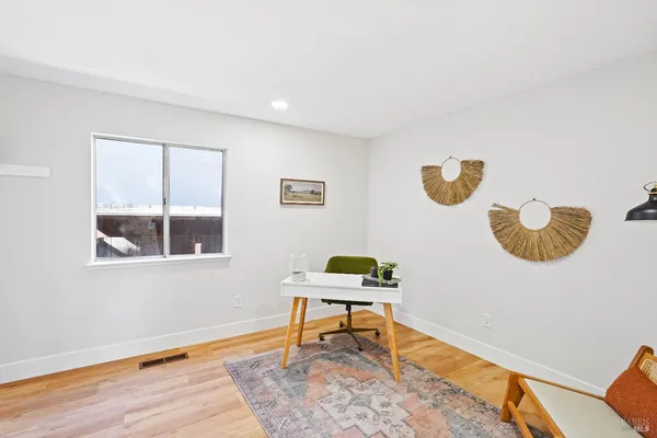 a workspace room with furniture and a window