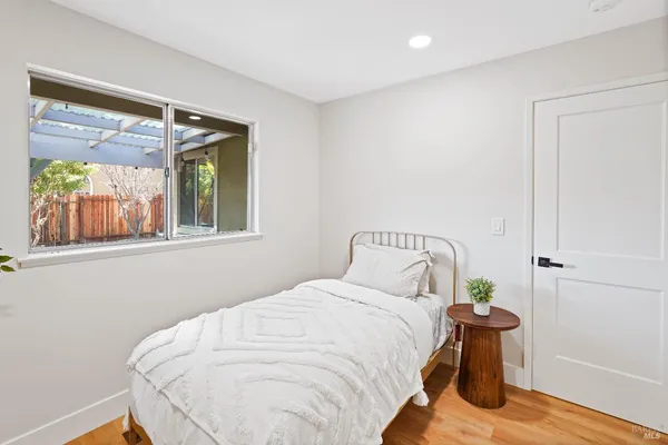 a bedroom with a bed and wooden floor