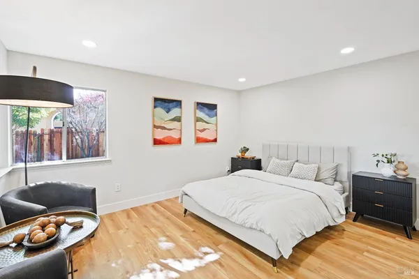 a bedroom with a bed and wooden floor
