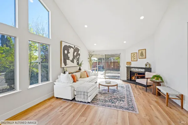 a living room with furniture and a floor to ceiling window