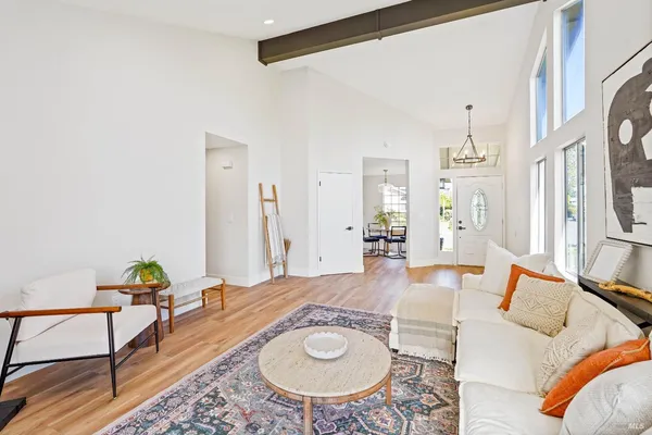 a living room with furniture and a dining table