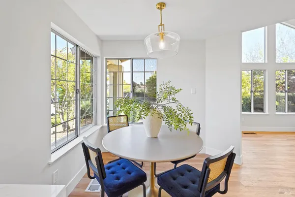 a view of a dining room with furniture window and wooden floor