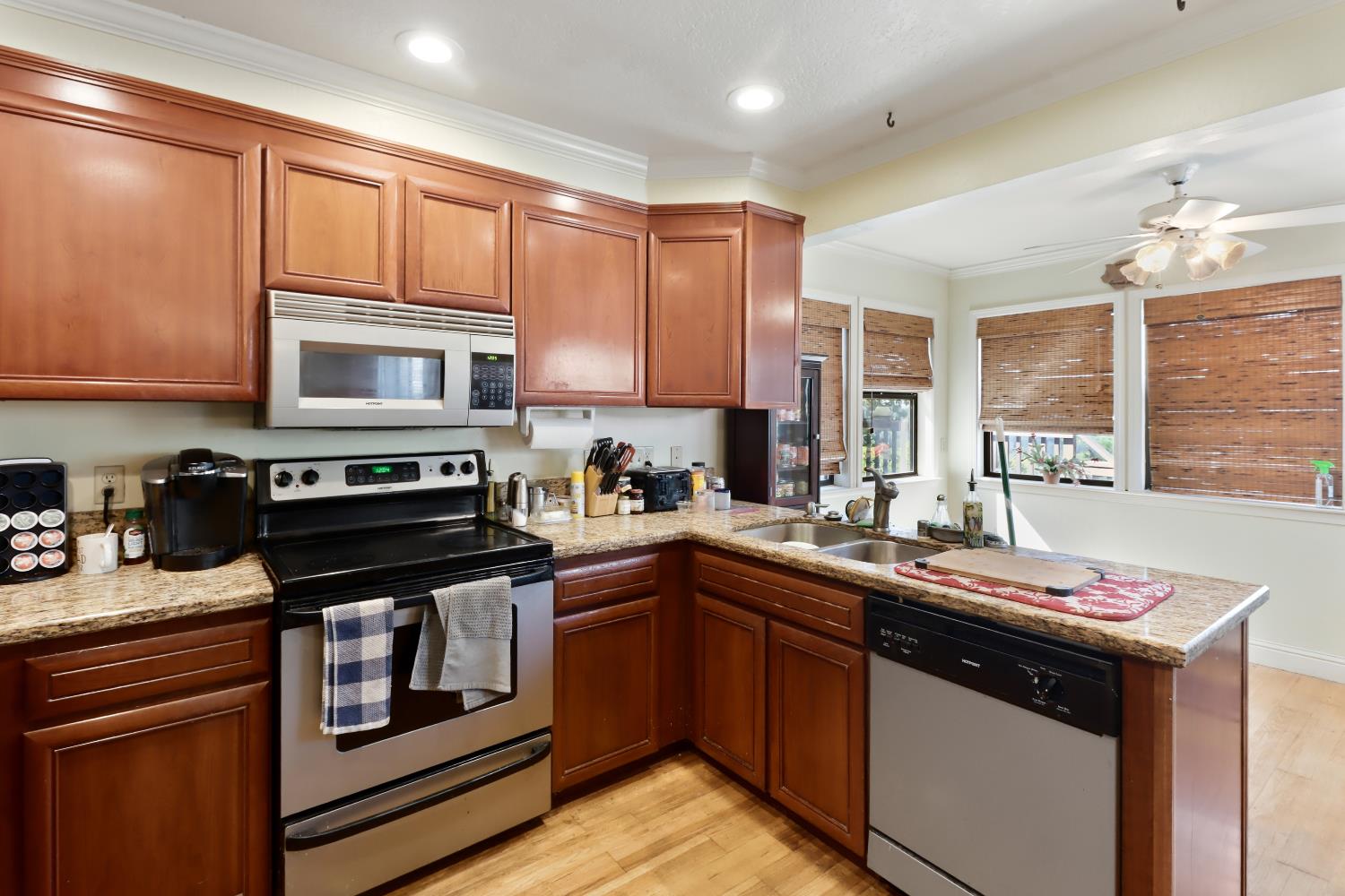 1635 Country Club Drive Placerville, CA 95667 - Photo 15 of 58 a kitchen with stainless steel appliances granite countertop a stove a sink dishwasher and a microwave oven with large cabinets