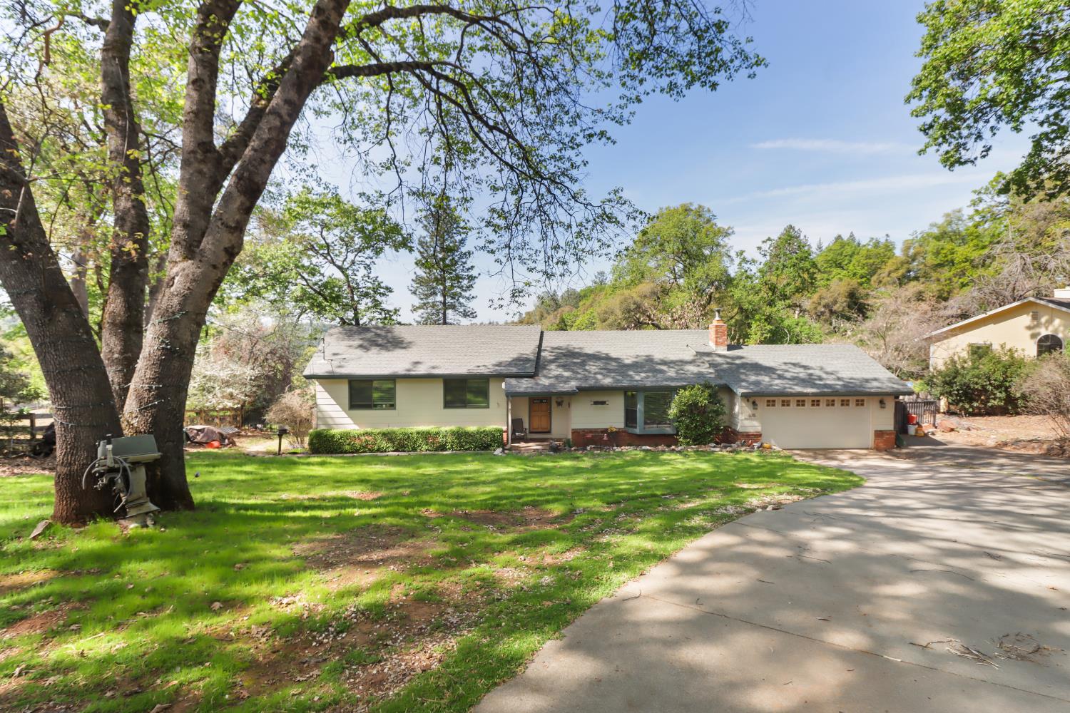 1635 Country Club Drive Placerville, CA 95667 - Photo 2 of 58 a front view of a house with a garden