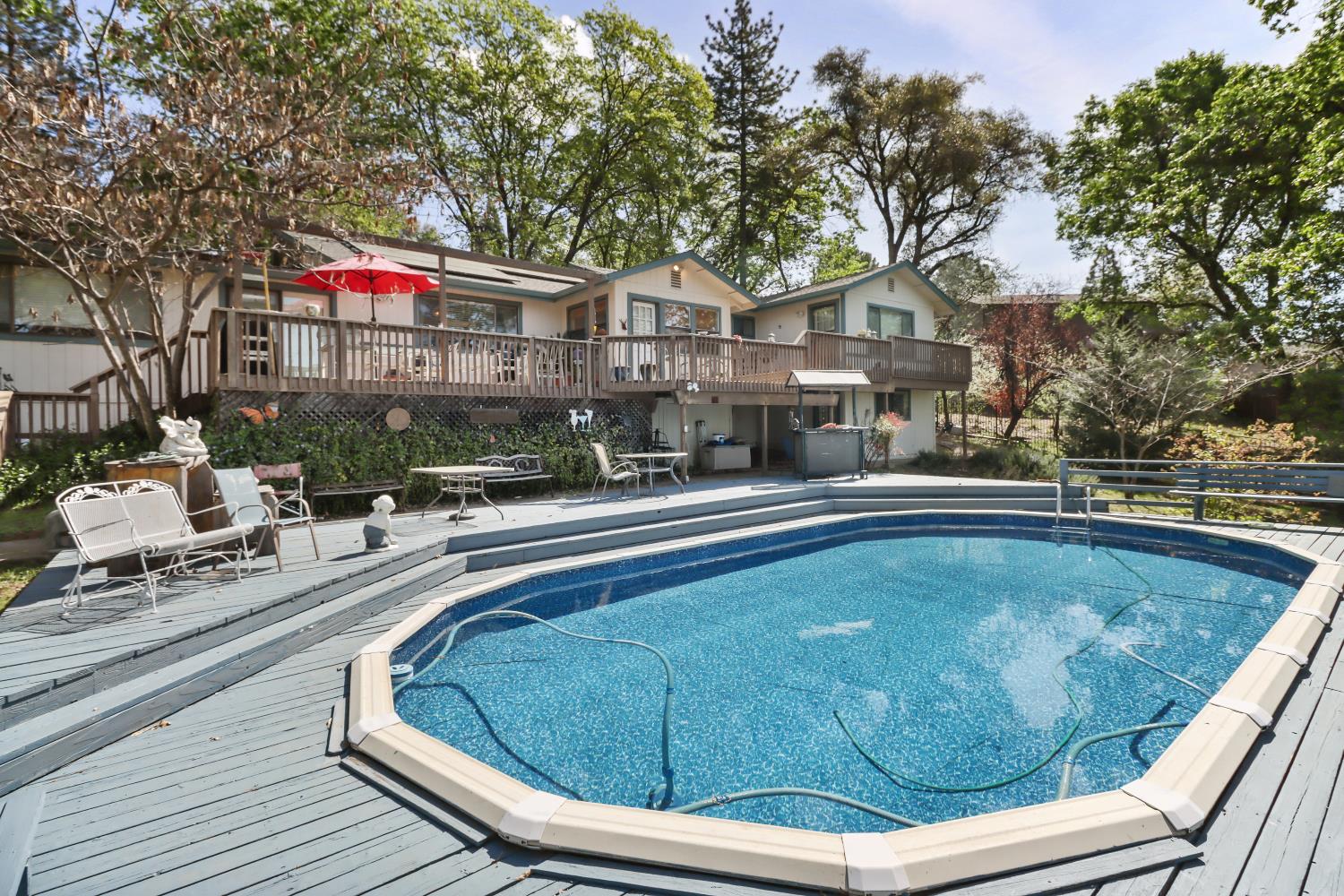 1635 Country Club Drive Placerville, CA 95667 - Photo 40 of 58 a view of a swimming pool with a lounge chairs