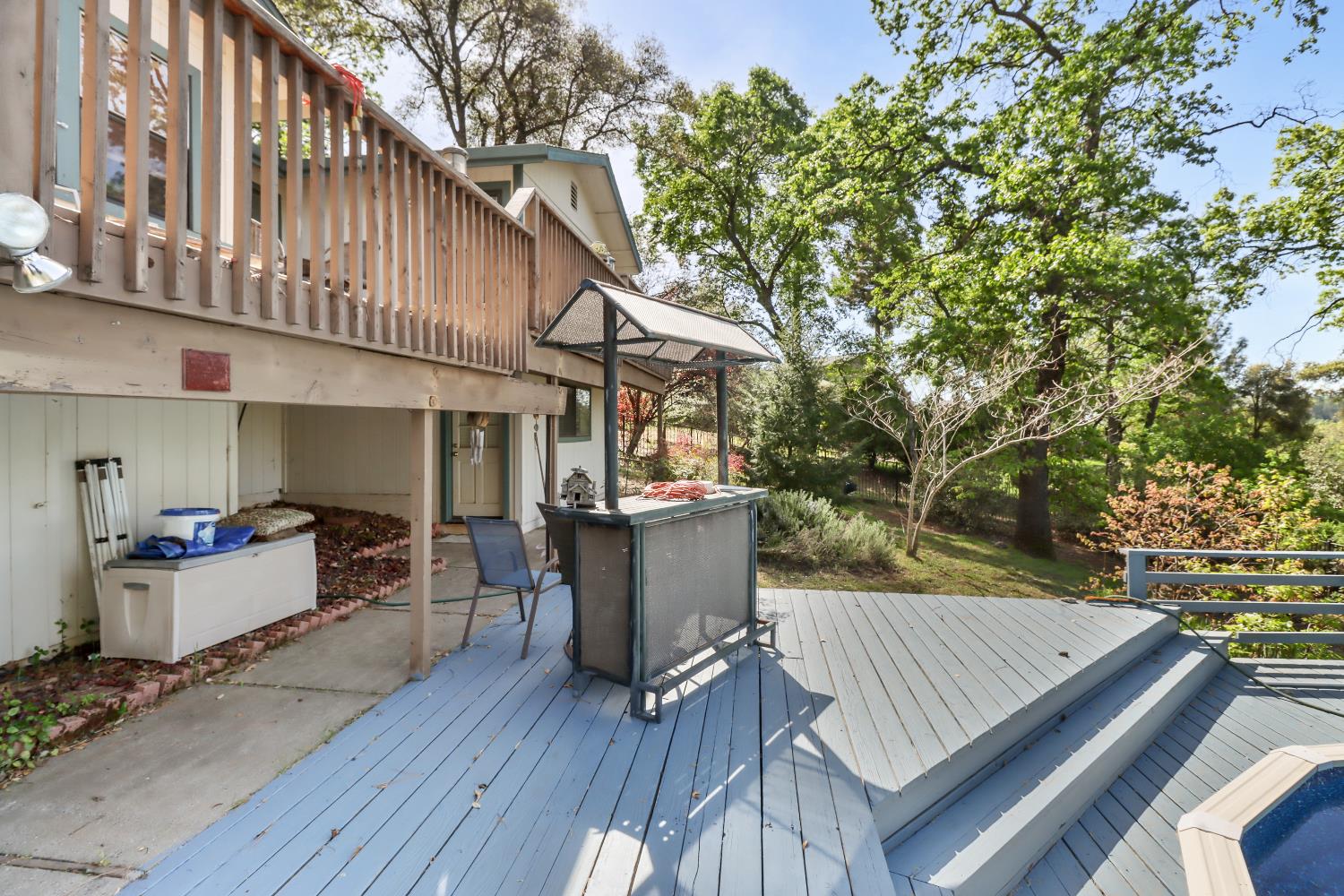 1635 Country Club Drive Placerville, CA 95667 - Photo 50 of 58 a view of a patio with table and chairs with wooden floor and fence and a barbeque