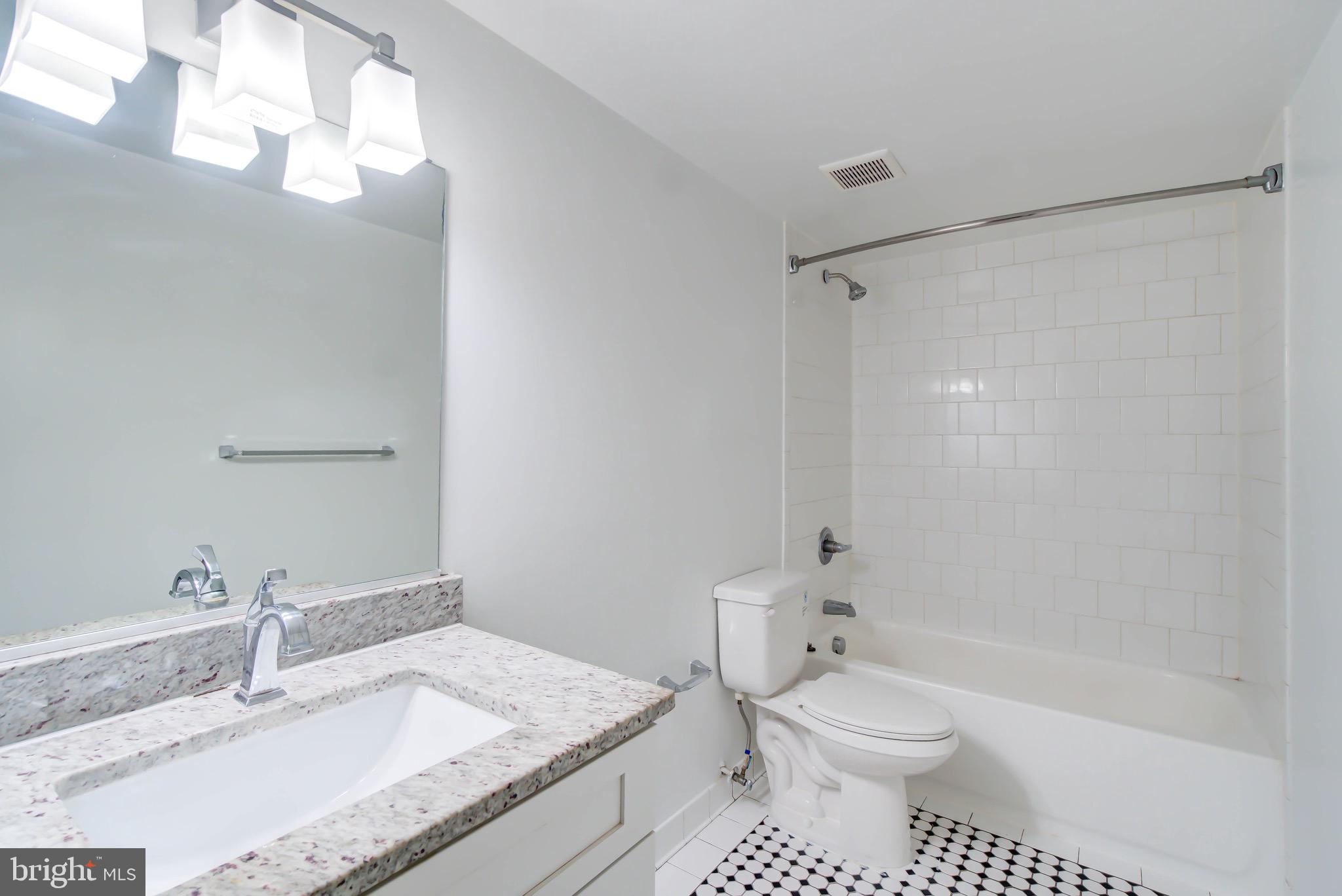3625 16th Street Northwest, Unit B1 Washington, DC 20010 - Photo 7 of 15 a bathroom with a granite countertop sink toilet and shower