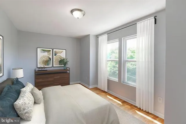 a bedroom with a bed and wooden floor