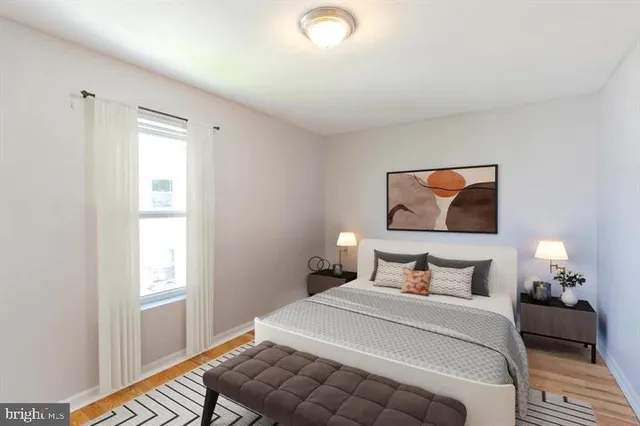 a bedroom with a bed and a painting on the wall