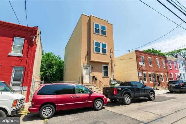 a view of a cars park in front of a building