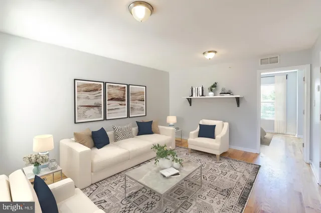 a living room with furniture and wooden floor