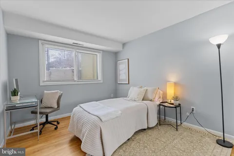 a bedroom with a bed a table and chair