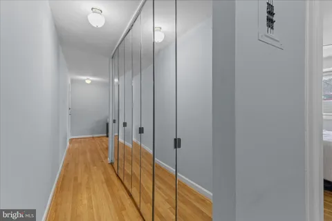 a view of a hallway with wooden floor