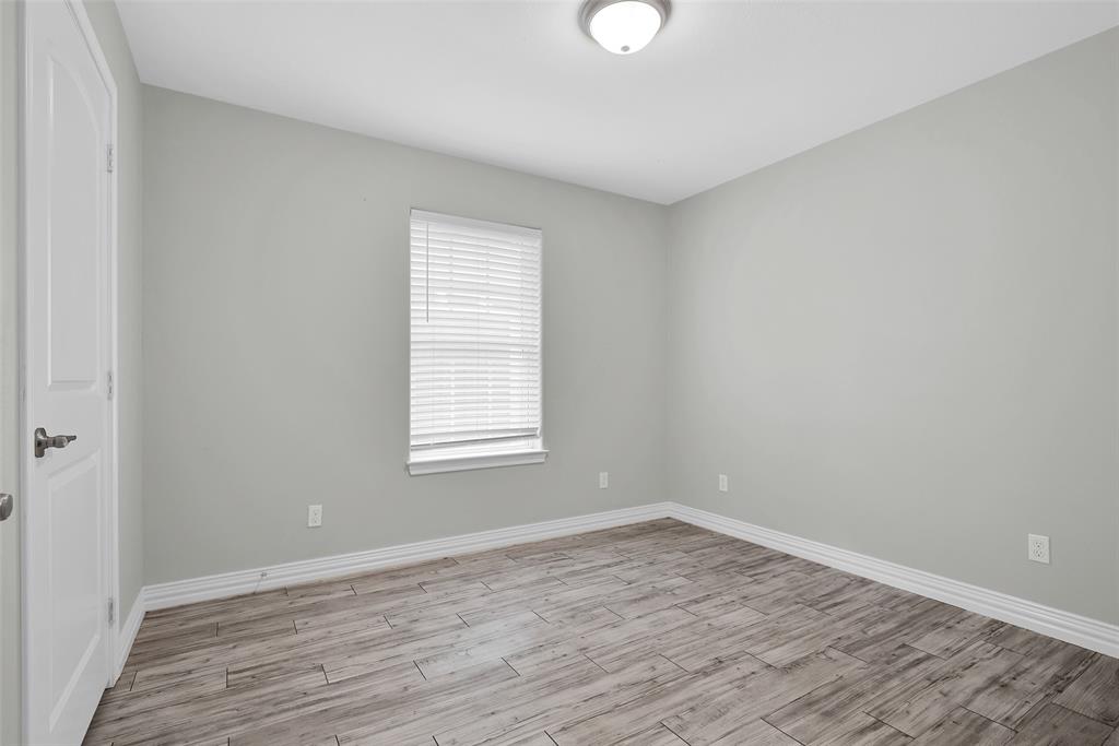 622 East Heron Street Denison, TX 75021 - Photo 12 of 20 Spare room featuring wood tiled floors and baseboards