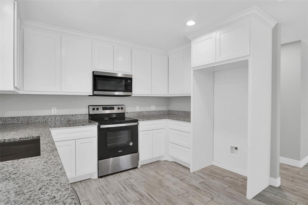 622 East Heron Street Denison, TX 75021 - Photo 10 of 20 Kitchen featuring stainless steel appliances, light stone counters, white cabinetry, recessed lighting, and light wood-type flooring