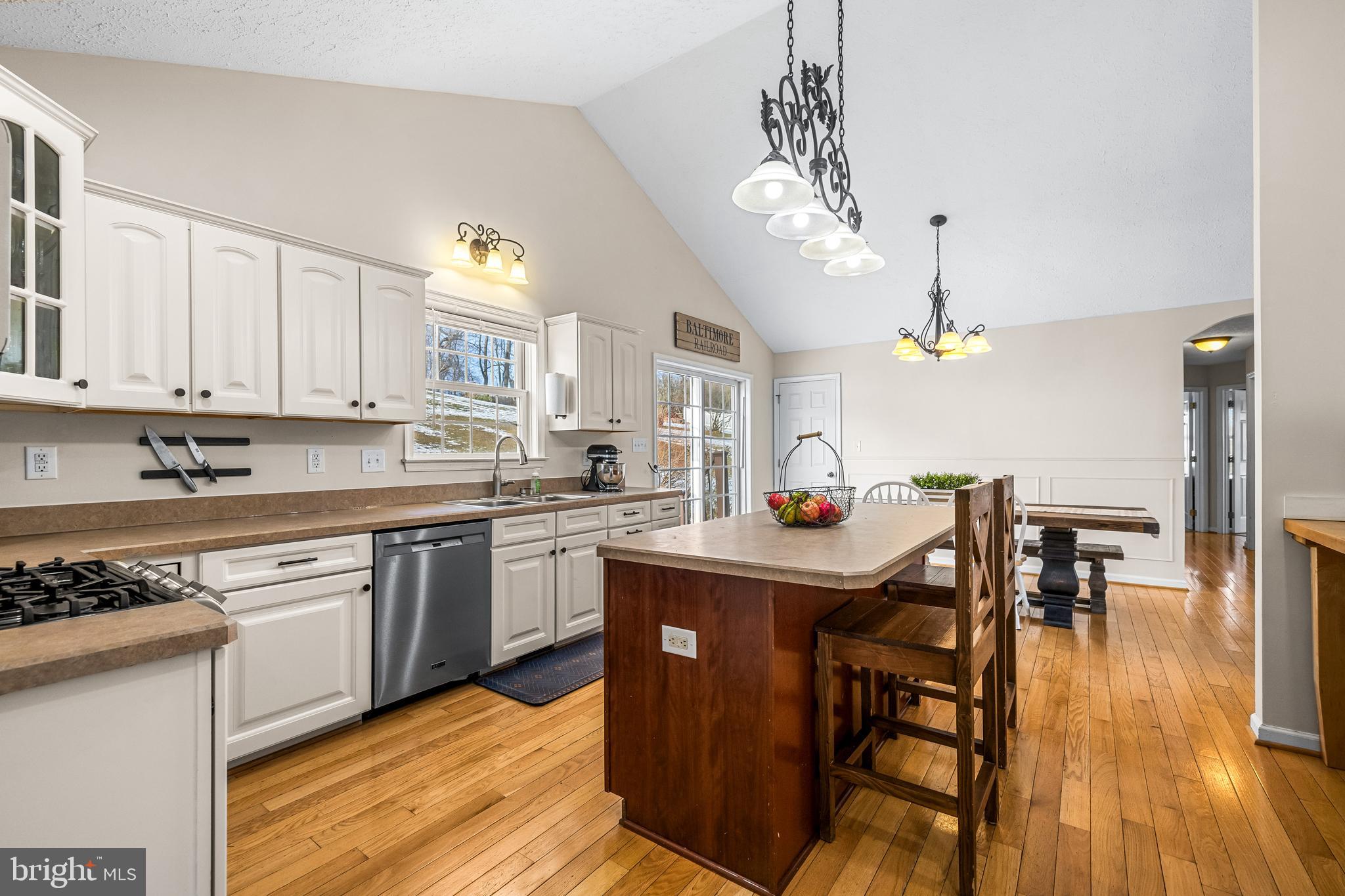 12270 High Point Road Felton, PA 17322 - Photo 12 of 45 a kitchen with stainless steel appliances granite countertop a stove refrigerator dining table and chairs