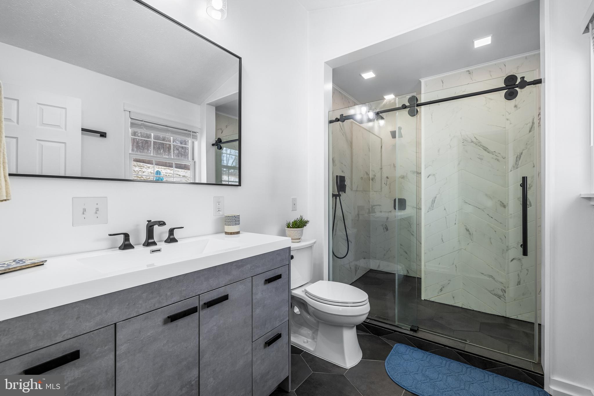 12270 High Point Road Felton, PA 17322 - Photo 24 of 45 a bathroom with a sink mirror toilet and shower