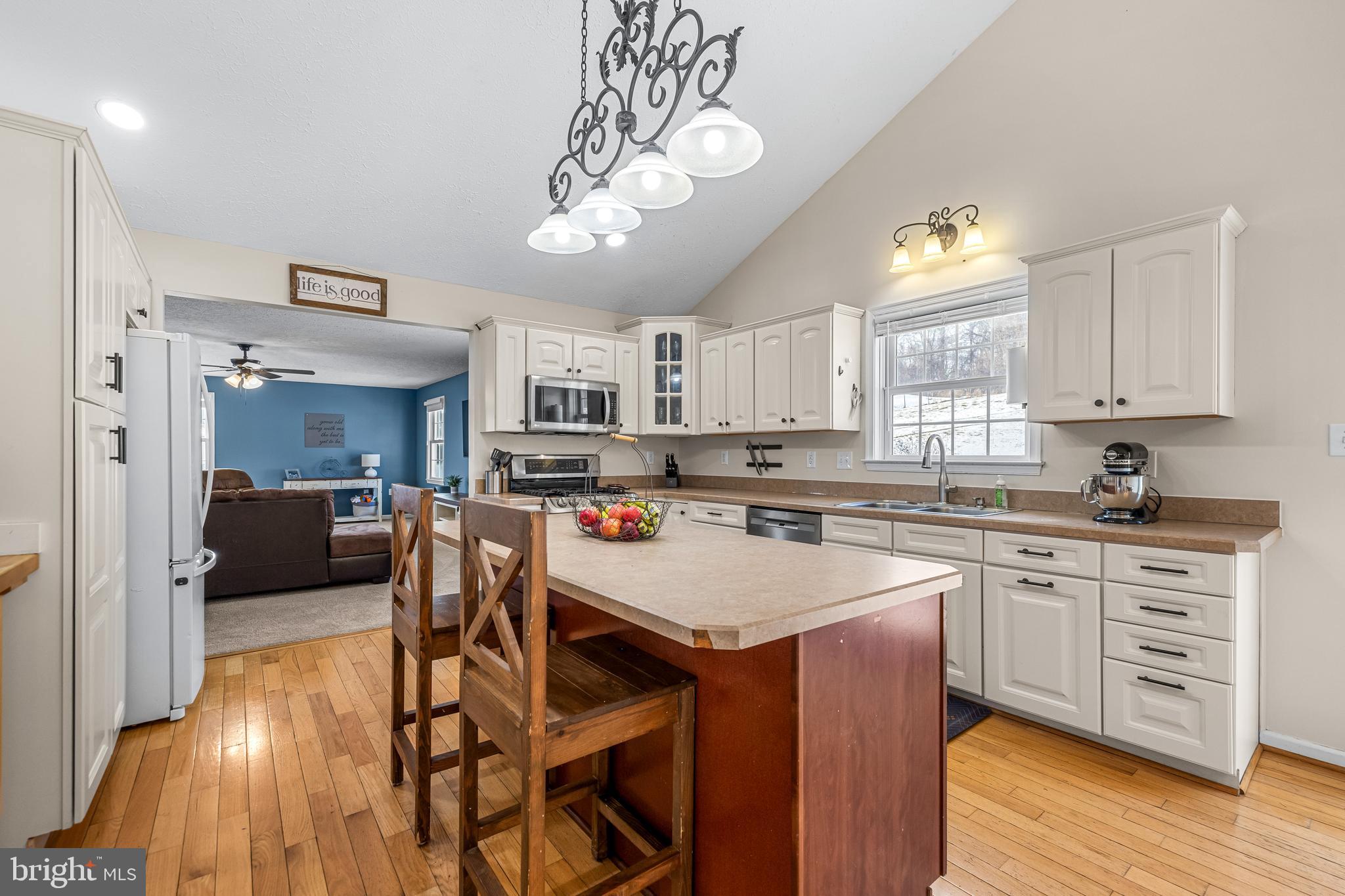 12270 High Point Road Felton, PA 17322 - Photo 10 of 45 a kitchen with a dining table chairs cabinets and stainless steel appliances