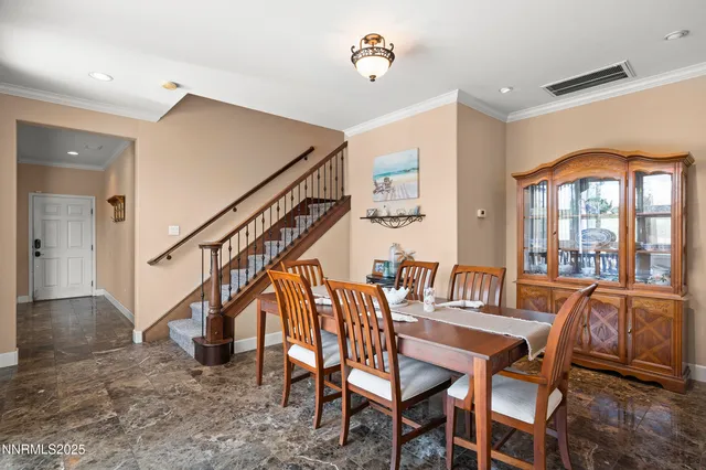 a dining room with furniture and entryway