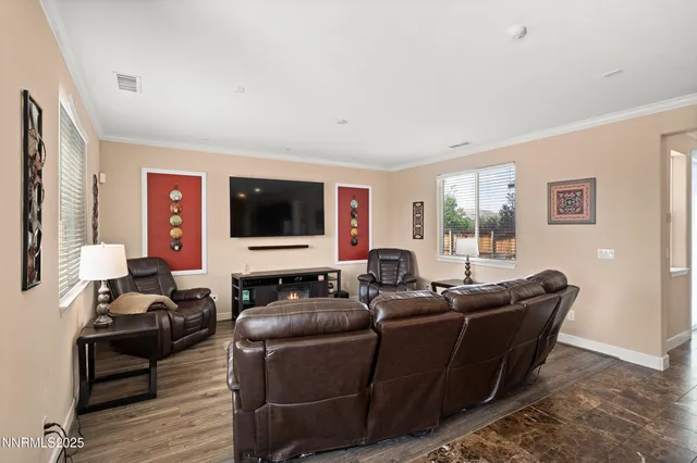 a living room with furniture window and a flat screen tv