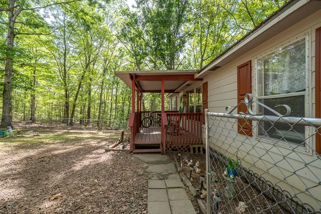 a view of a patio with table and chairs under an umbrella