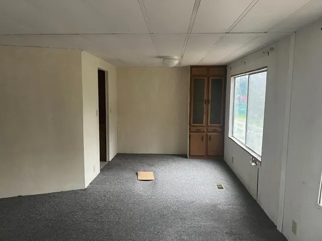 a view of empty room with a fireplace