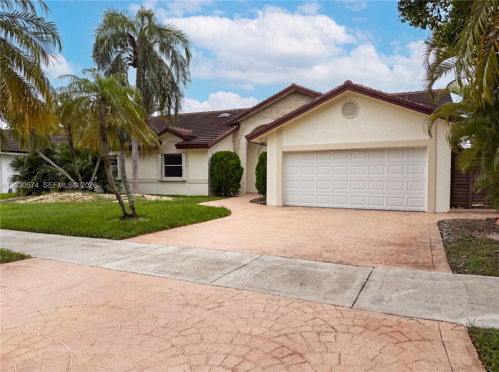 16571 Southwest 145th Avenue Miami, FL 33177 - Photo 21 of 25 a view of a white house with a yard and potted plants