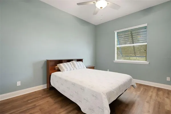 a large bed sitting in a bedroom next to a window