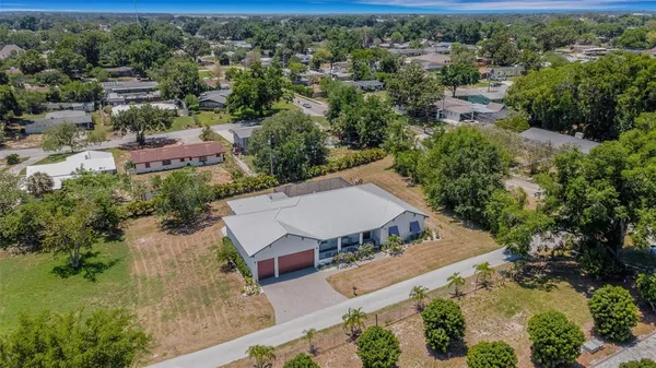 an aerial view of a house with yard swimming pool and outdoor seating