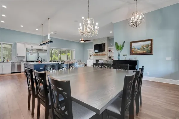 a view of a dining room with furniture wooden floor and chandelier