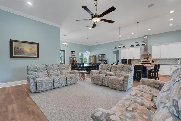 a living room with furniture and kitchen view